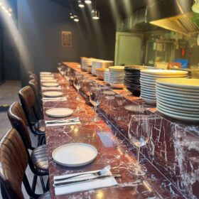 Stylish marble chef’s counter set for an intimate dining experience at Zula Grill, the best grill restaurant in Hackney.