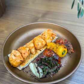 Grilled chicken shish served on warm flatbread with seasonal Turkish sides at Zula Grill, the best Turkish restaurant in Homerton.