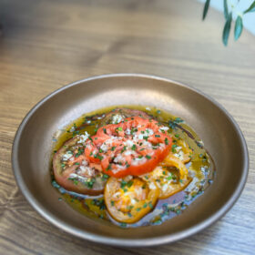 A refreshing heirloom tomato salad with herbs and olive oil at Zula Grill, the best Turkish restaurant in Homerton.